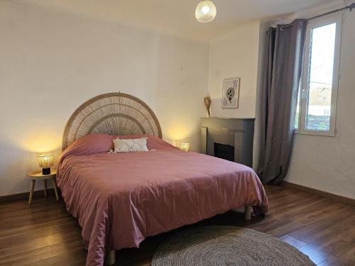 a bedroom with a large bed and a window at La charmante in Puyoô