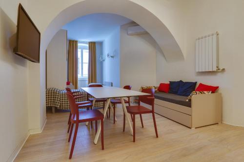 a dining room with a table and chairs and a couch at Residence Al Granzo in Trieste