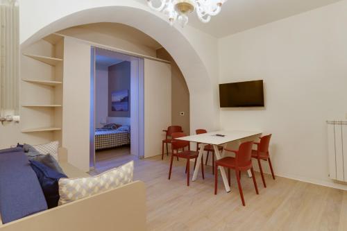 a living room with a table and chairs at Residence Al Granzo in Trieste