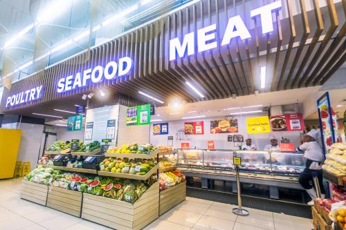 a grocery store aisle with a meat counter in a store at Urban Charm Cozy Meet 51 Air Swim Gym Park 300Mb in Manila