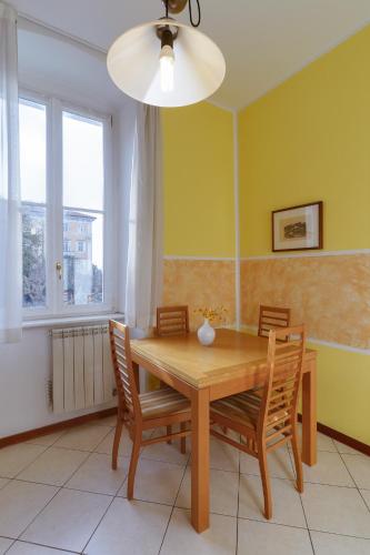 a dining room with a wooden table and chairs at Residence Al Granzo in Trieste