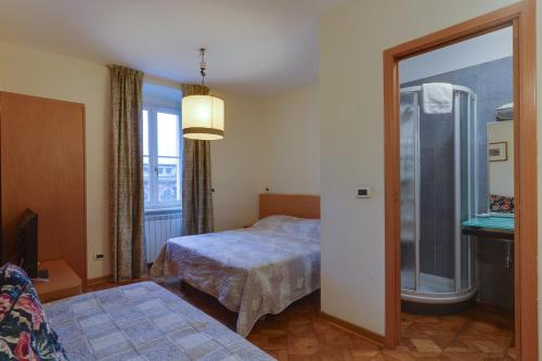 a bedroom with a bed and a window and a mirror at Residence Al Granzo in Trieste