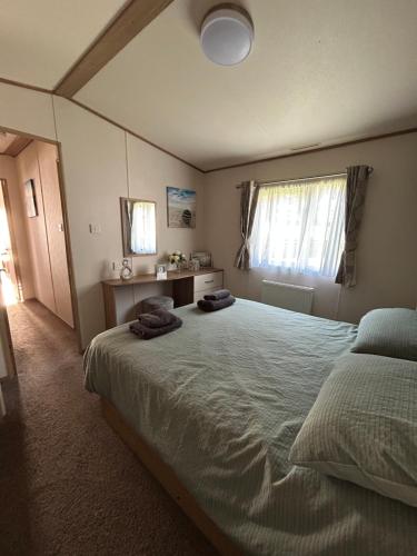 a bedroom with a large bed with two towels on it at Uisge Beatha in Dornoch