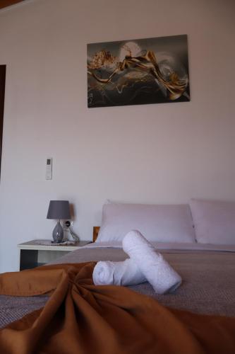 a towel laying on a bed in a bedroom at Bujtina ANLU in Gjirokastër