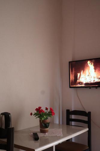 a room with a table with a fire on the wall at Bujtina ANLU in Gjirokastër