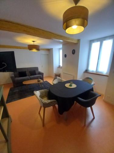 un salon avec une table et un canapé dans l'établissement appartement coeur de ville Laruns 2 ou 3 personnes, à Laruns