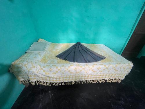 a bed with a blanket with a umbrella on it at Thapovanam in Allaippiddi