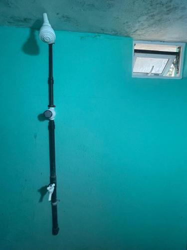 a blue wall with a street light and a window at Thapovanam in Allaippiddi