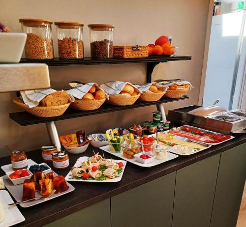 a buffet with many plates of food on a table at Indium City Panzió in Eger
