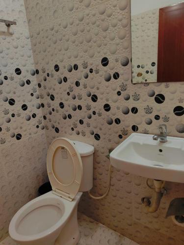 a bathroom with a toilet and a sink at Janatha Homestay in Cochin