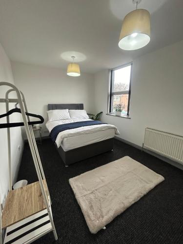 a bedroom with a bed and a ladder in it at Spacious Apartment near train station with a parking space in Birmingham
