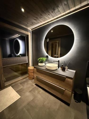 a bathroom with a sink and a mirror at Lyngen Vista - Arctic Luxury in Hamnnes