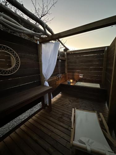 a wooden deck with a bench and a tub at 海好きな大人の隠れ家下田ハウス in Shimoda