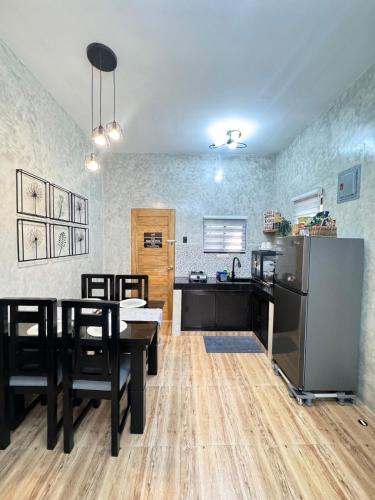 a kitchen and dining room with a table and chairs at Pio Transient House in Tanay