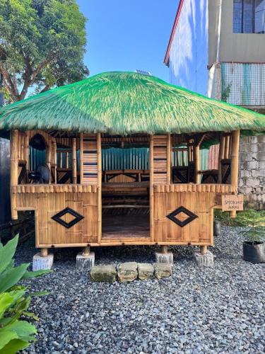 a bamboo hut with a grass roof at Pio Transient House in Tanay