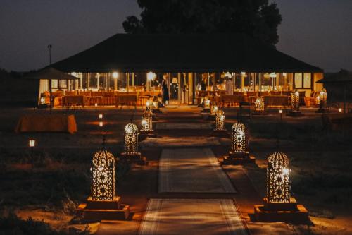 a wedding venue with lights at night at Paradise Luxury Camp in Merzouga