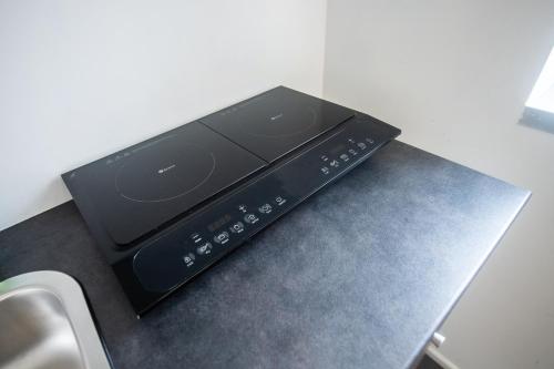 a black microwave sitting on top of a counter at Loft zona Stazione Centro con Wi Fi, Cucina & Parking Free in Parma