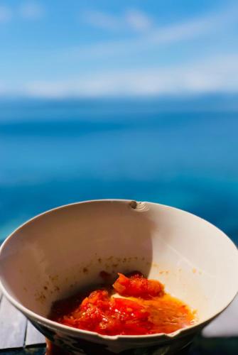 a pot of food with sauce in it at Korbekwan Homestay in Besir