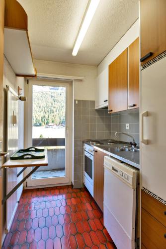 a kitchen with a sink and a dishwasher at Chesa Allegria - Sils Maria in Sils Maria