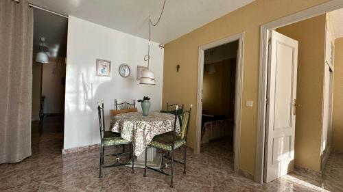 a dining room with a table with a vase on it at Apartament GECO - near the beach in Lo Pagan in San Pedro del Pinatar