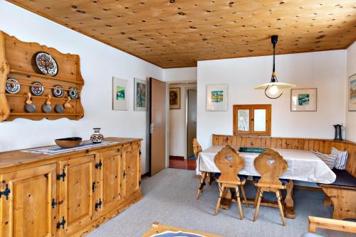 a kitchen and dining room with a table and chairs at Chesa Allegria - Sils Maria in Sils Maria