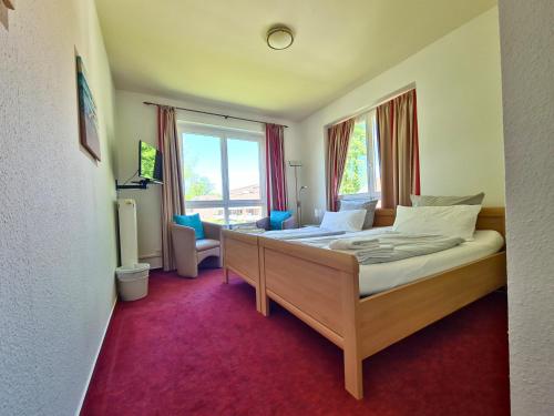 a bedroom with a bed and a large window at Zeitlos Hotel Garni in Scharbeutz