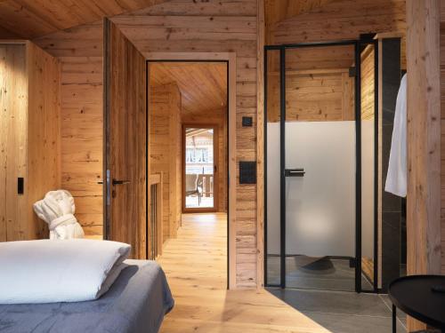 a bedroom with a bed and a glass door at My Chalet in Meiringen