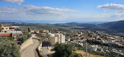 a view of a city from a hill at אחוזת מצפה שני הימים-וילת 7 חדרים עם בריכה מחוממת וג'קוזי ספא in ‘Ein el Asad