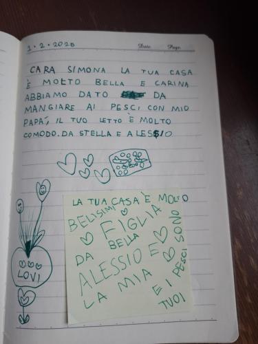 a book with someones handwriting on a sheet of paper at Casa Poldo in Cantello