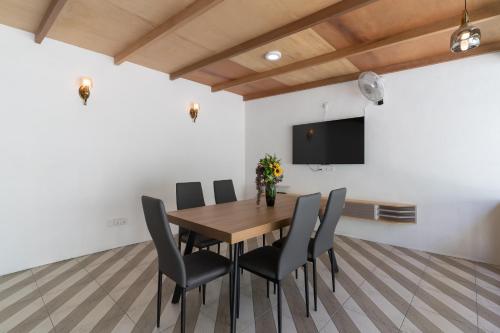 a dining room with a wooden table and chairs at La Liviera in Ukulhas