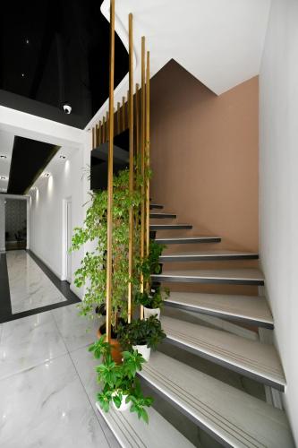 a lobby with stairs with plants on them at Mon Invite Hotel in Yerevan