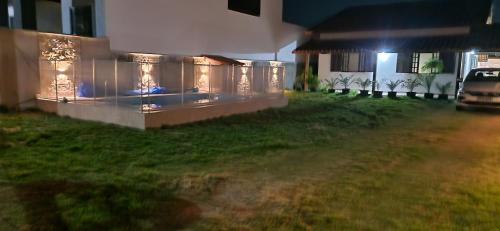a house with a car parked in a yard at night at Holidays in Itaipuaçu Beach in Maricá