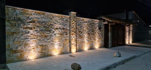 a brick wall with lights on it at night at Holidays in Itaipuaçu Beach in Maricá