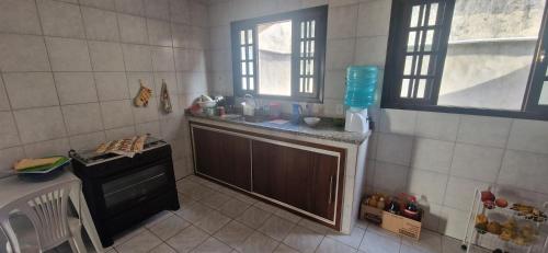 a small kitchen with a sink and a window at Holidays in Itaipuaçu Beach in Maricá