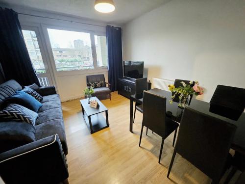a living room with a couch and a table at Wellington Apartment in London
