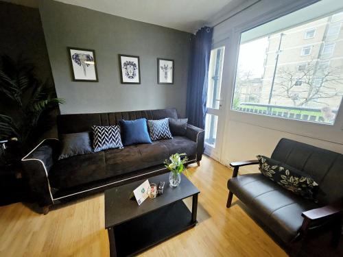 a living room with a couch and a table at Wellington Apartment in London
