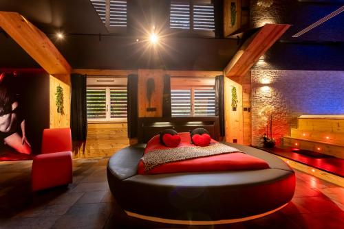 a room with a bed with two teddy bears on it at Love Room Tentation in Ornans