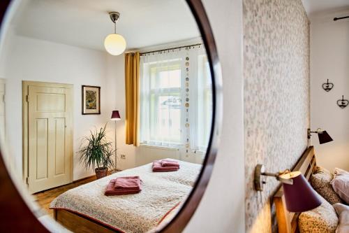 a bedroom with two beds and a mirror at Vila Betula in Nové Město na Moravě