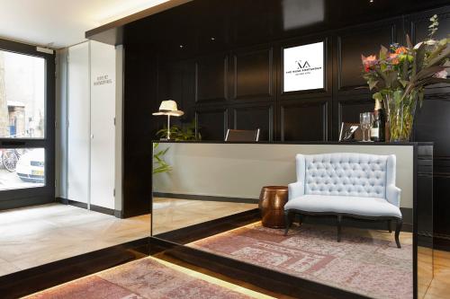 a lobby with a chair and a reception desk at The Muse Amsterdam - Boutique Hotel in Amsterdam