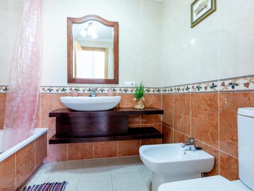 a bathroom with a sink and a toilet and a mirror at Sea breeze Sotavento III in La Tejita