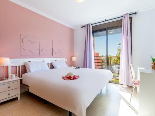a bedroom with a white bed and a large window at Sea breeze Sotavento III in La Tejita