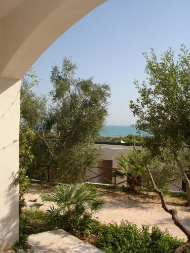 a view of the ocean through an archway at Baia Degli Aranci Suite & Apartments in Vieste