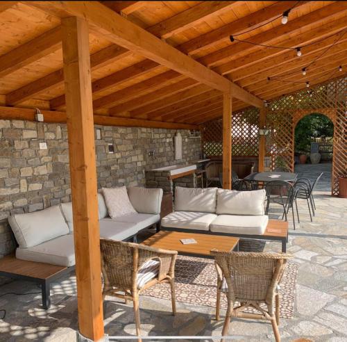 a patio with couches and a table and chairs at Peaceful Mountain Retreat - private guest house in Gorreta