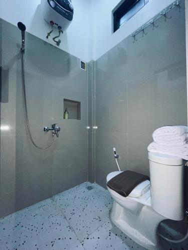 a bathroom with a shower and a toilet in it at SALU AMAANA Residence Syariah in Wonosobo
