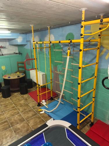 a play room with a climbing wall and a climbing ladder at La Maison du Bonheur in Gouvy
