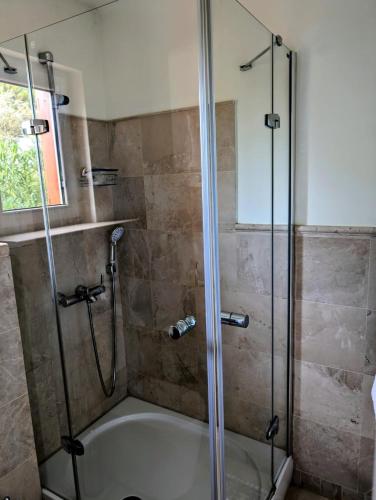 a bathroom with a shower and a bath tub at Belvedere, LaVanta, Kalkan in Kalkan