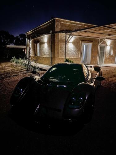 a car parked in front of a house at night at Residenza Case Arse in Torre Lapillo