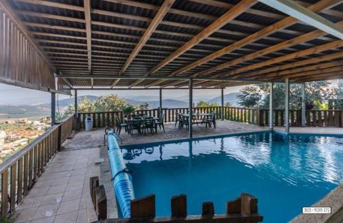 a swimming pool with a water slide at אחוזת מצפה שני הימים-וילת 7 חדרים עם בריכה מחוממת וג'קוזי ספא in ‘Ein el Asad