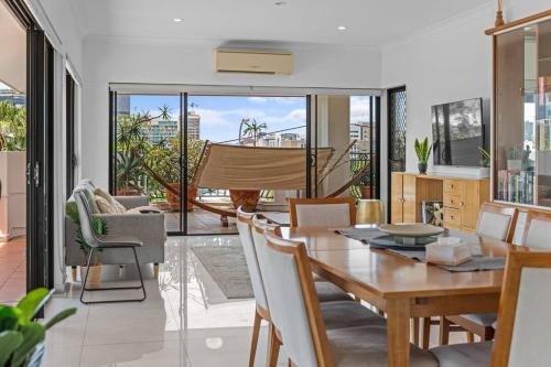 a dining room with a table and chairs at Lux Penthouse, Private Rooftop in Brisbane