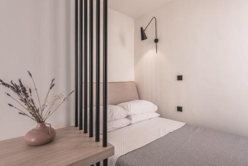 a bedroom with a bed and a clock on the wall at Yria Hotel in Zakynthos Town